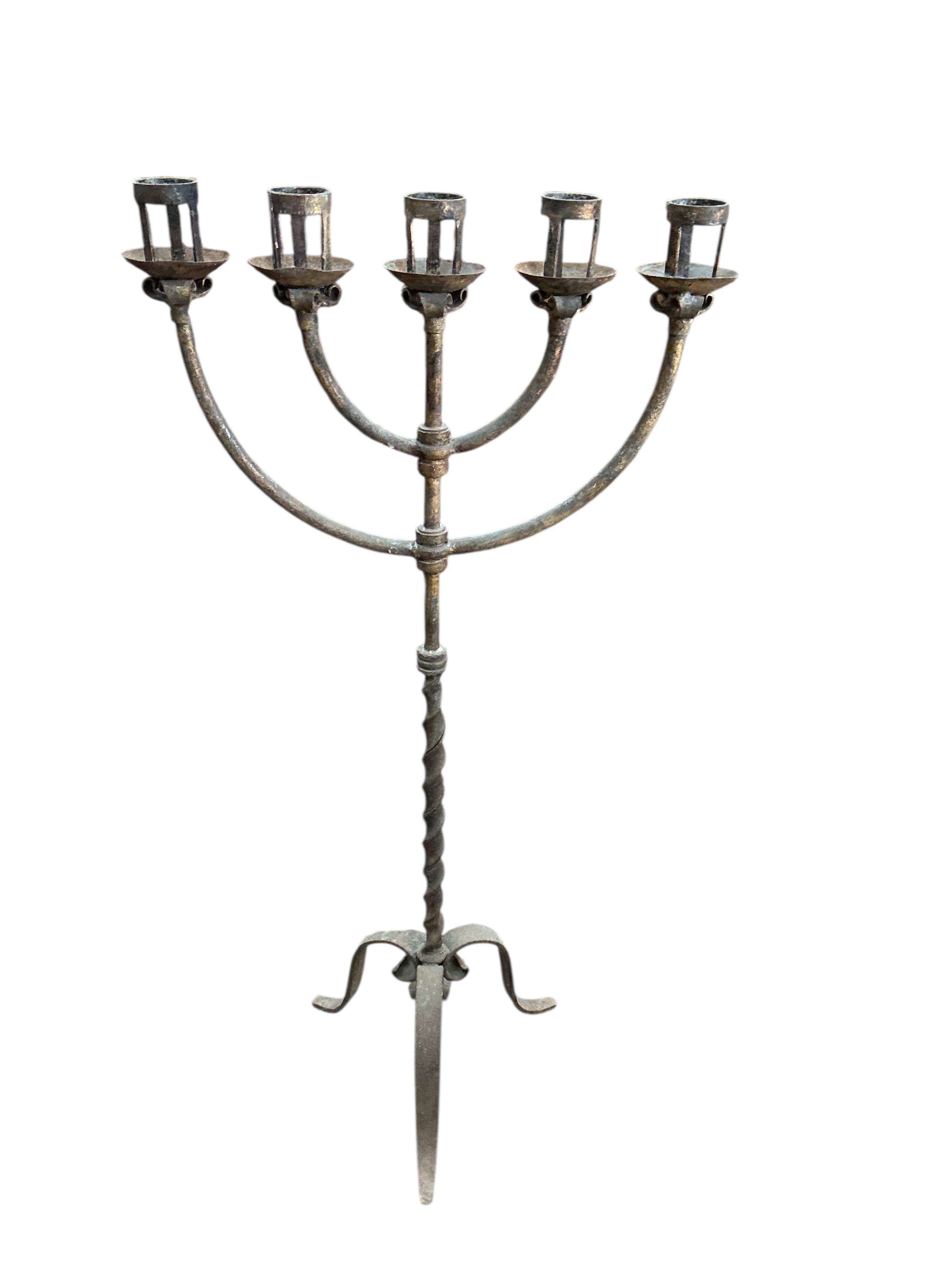 A wrought iron five branch tripod candlestand, height 134cm together with a wrought iron dragon head hanging light fitting